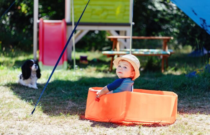 baby sitting in an inflatable pool in the backyard